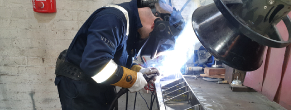 Visual Weld Inspector welding a flux core weld on fabricated seating